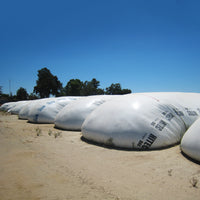 Large white silage bags by HITEC on a farm