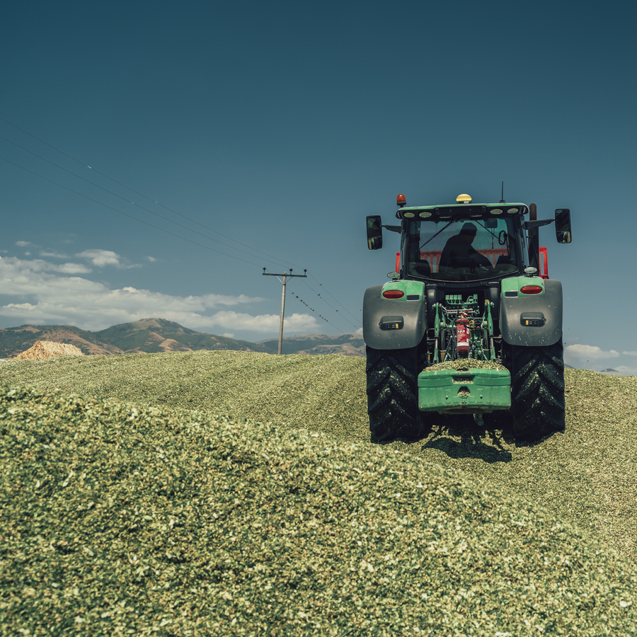 Tractor compacting silage on a farm, part of HITEC’s agricultural solutions
